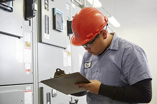 MCES plant operator Thatee Yang inspects equipment at the Metro Plant Solids Management Building in Saint Paul